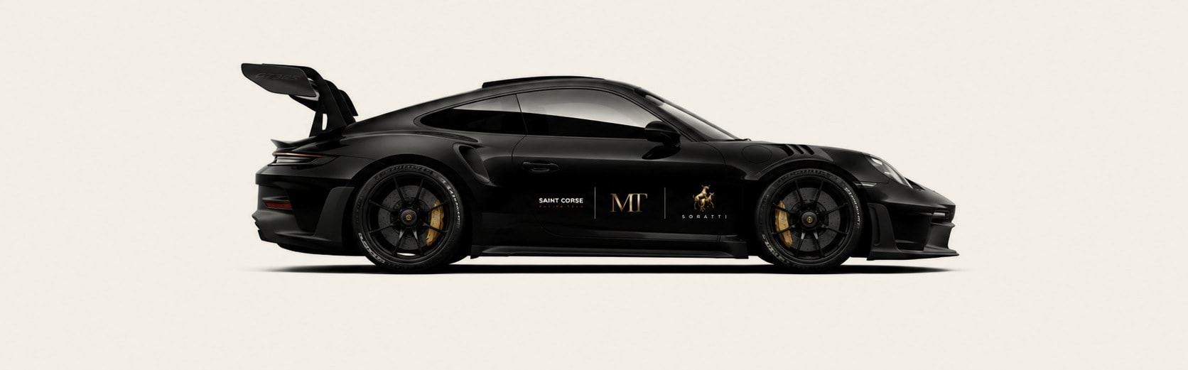 Black Porsche 911 GT3 RS in side profile carrying the Saint Corse, MT and SORATTI marks on the door.